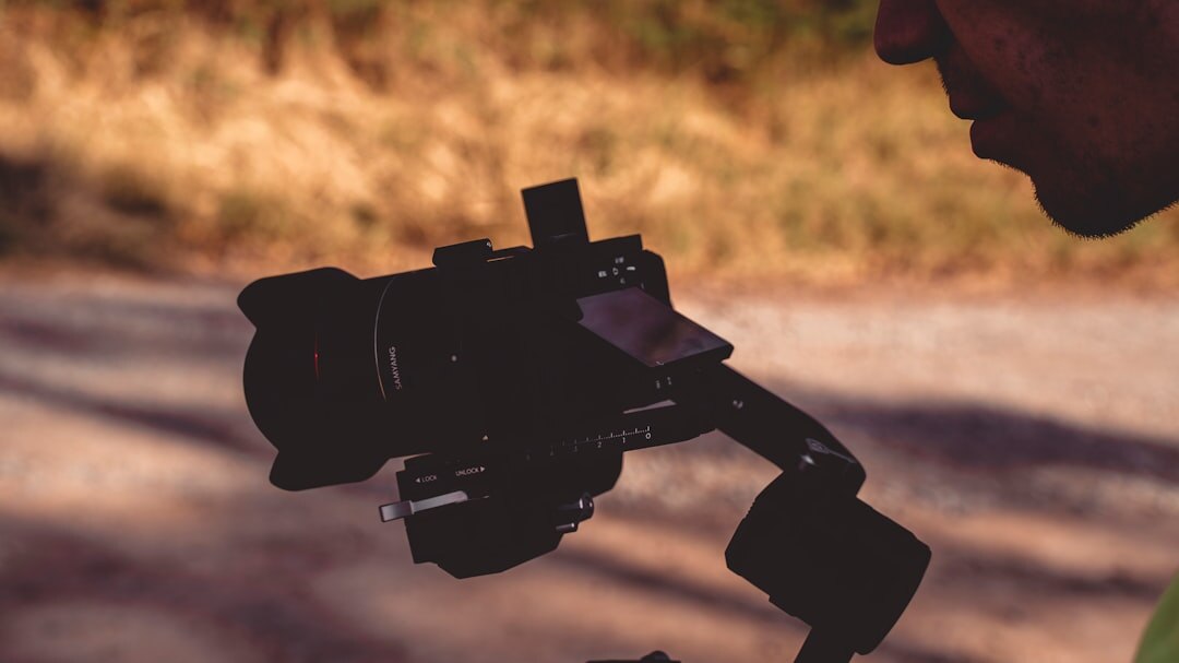 Camera operator tracking a parade with a gimbal