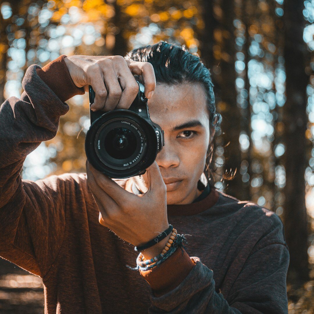 Belgian male video instructor with a camera